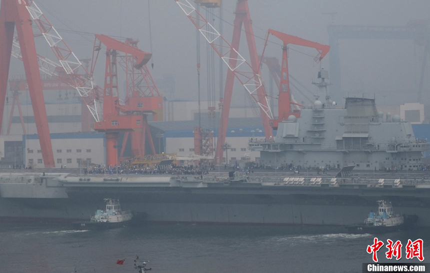 China's aircraft carrier platform returns to the dock in Dalian, northeast China’s Liaoning Province, after finishing its 9th sea trial,July 30, 2012. The trial lasted 25 days, the longest one in its history. 