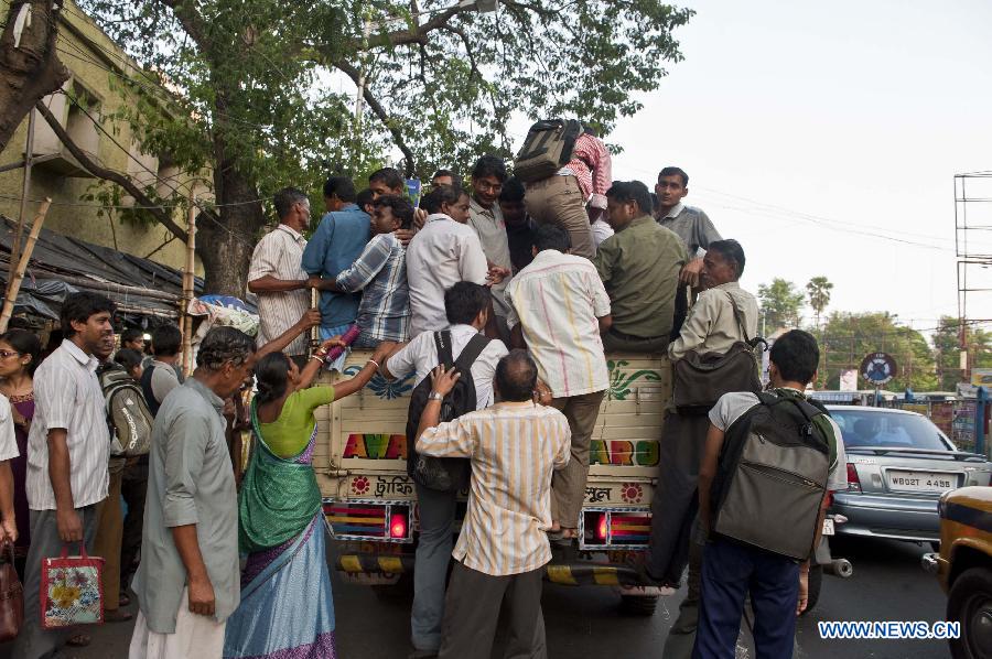 Indian commuters try to get on a truck as the public transportation is packed due to power cut in Calcutta, capital of eastern Indian state West Bengal, India, July 31, 2012. More than half of Indian population were affected Tuesday after a massive power outage hit the country for the second day in a row.