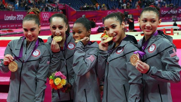  USA women celebrate artistic gymnastics team win.