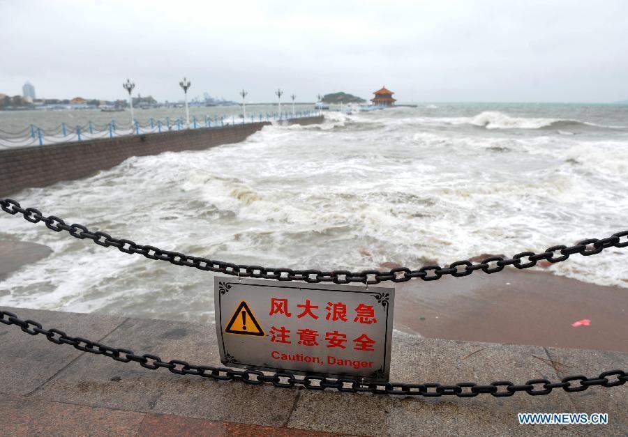 Photo taken on Aug. 3, 2012 shows a warning board on the shore in Qingdao as the Typhoon Saola approaches in Qingdao, east China's Shandong Province. Shandong Provincial Meteorological Station has issued the red alert for the Typhoon Saola, the highest warning level in China's four-tier weather warning system. (Xinhua/Li Ziheng) 