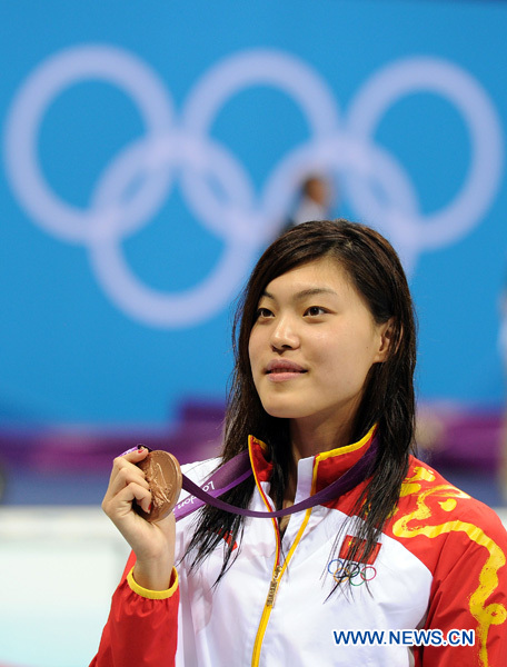 Tang Yi of China poses at awarding ceremony of women's 100m freestyle of swimming competition, at London 2012 Olympic Games in London, Britain, August 2, 2012. Tang Yi won the bronze medal with 53.44. [Xinhua]