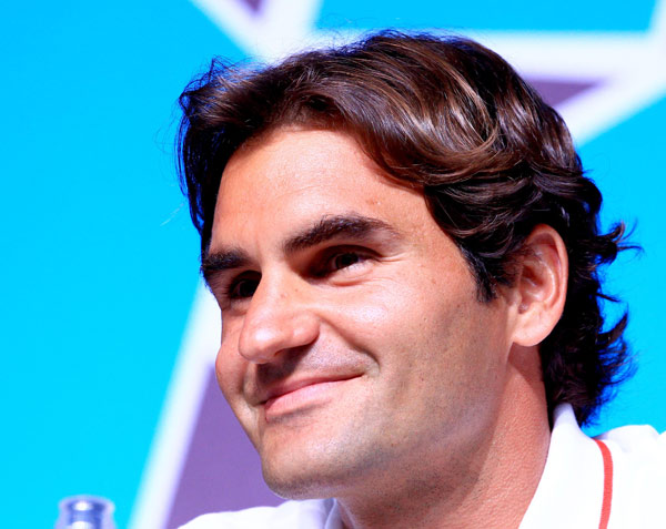 Swiss tennis player Roger Federer speaks during a press conference at the Main Press Center (MPC) in London, Britain, July 26, 2012. [Chen Jianli/Xinhua]