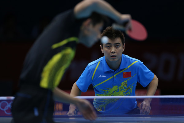 Wang Hao of China (in blue) competes with Zhang Jike of China during men's table tennis singles final match, at London 2012 Olympic Games in London, Britain, on August 2, 2012.