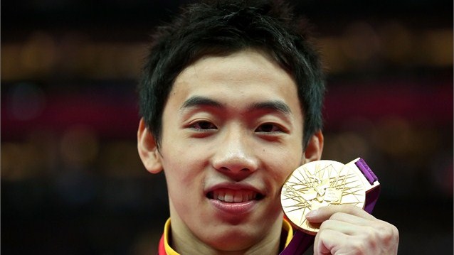 Zou Kai celebrates with his gold medal during the Victory Ceremony for the men's Floor competition on Day 9 at London 2012.  