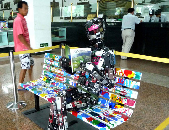 A robot model made from hundreds of used cell phones on display in a post office in Beijing last year. [China Daily]