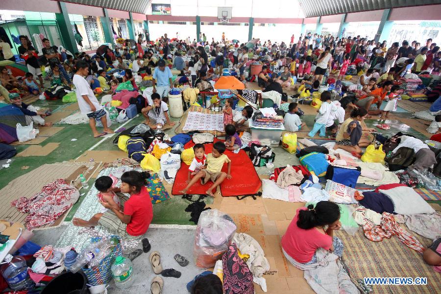 Displaced residents take shelter in an evacuation center in Marikina City, the Philippines, Aug. 8, 2012. Eleven people died, while over one million were displaced as torrential rains brought by the southwest monsoon flooded large parts of Metro Manila and nine provinces in northern and central Philippines.