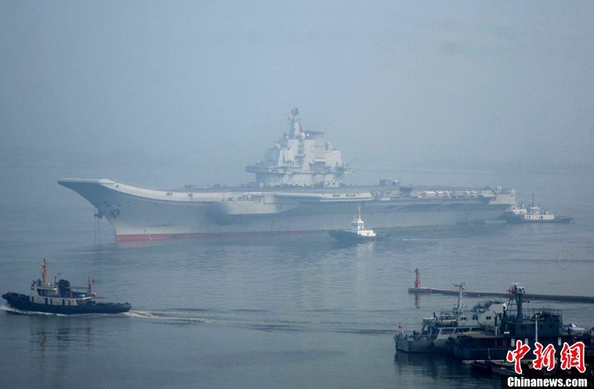 China's aircraft carrier platform returns to the dock in Dalian, northeast China's Liaoning Province, after finishing its 9th sea trial, July 30, 2012. The trial lasted 25 days, the longest one in its history.