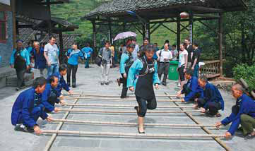 Local residents perform a bamboo dance to greet guests to Shuitou village.