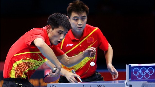 Zhang Jike (L) and Wang Hao of China compete against the Republic of Korea during the men's team table tennis gold medal match on Day 12.