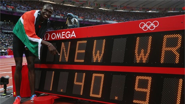 David Rudisha of Kenya celebrates next to the clock after winning gold and setting a new world record in the men's 800m final on Day 13 of the London 2012 Olympic Games at Olympic Stadium.  