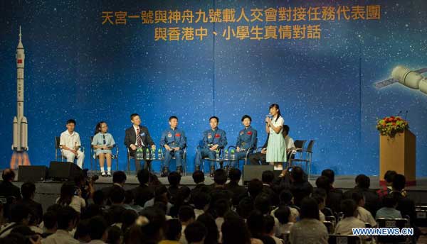 Shenzhou-9 astronauts Liu Wang (4th L), Jing Haipeng (5th L) and Liu Yang (6th L) listen to a local student's speech in Hong Kong, south China, Aug. 11, 2012. A dialog between astronauts, Jing Haipeng, Liu Wang and Liu Yang who partook in China's Tiangong-1/Shenzhou-9 space docking mission, and Hong Kong students was held Saturday at the Hong Kong Convention and Exhibition Center. [Xinhua]