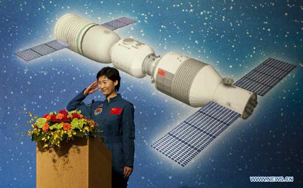 Shenzhou-9 astronaut Liu Yang salutes during a dialog with local students in Hong Kong, south China, Aug. 11, 2012. A dialog between astronauts, Jing Haipeng, Liu Wang and Liu Yang who partook in China's Tiangong-1/Shenzhou-9 space docking mission, and Hong Kong students was held Saturday at the Hong Kong Convention and Exhibition Center. [Xinhua]