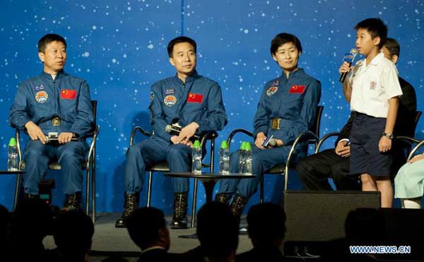 Shenzhou-9 astronauts Liu Wang, Jing Haipeng and Liu Yang (L-R) listen to a local student's speech in Hong Kong, south China, Aug. 11, 2012. A dialog between astronauts, Jing Haipeng, Liu Wang and Liu Yang who partook in China's Tiangong-1/Shenzhou-9 space docking mission, and Hong Kong students was held Saturday at the Hong Kong Convention and Exhibition Center. [Xinhua]