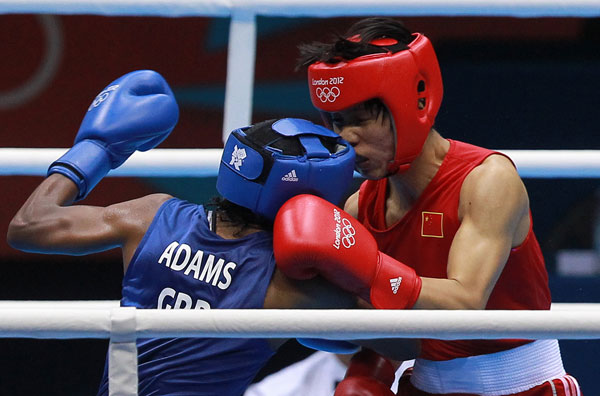 Ren Cancan of China (right) fights Nicola Adams of Great Britain during the women's boxing flyweight final at the 2012 London Games on Thursday. Adams won to claim the event's inaugural gold medal. [China Daily]