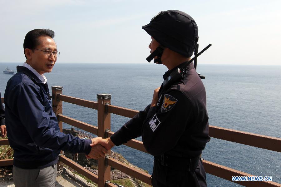 South Korean President Lee Myung-bak visits a set of disputed islets called Dokdo in Korean and Takeshima in Japanese, east of Seoul, Aug. 10, 2012. The president paid a landmark visit Friday to a set of disputed islets claimed by both South Korea and Japan after a stop on the nearby Ulleung Island, an unprecedented trip that raised Tokyo's ire. 