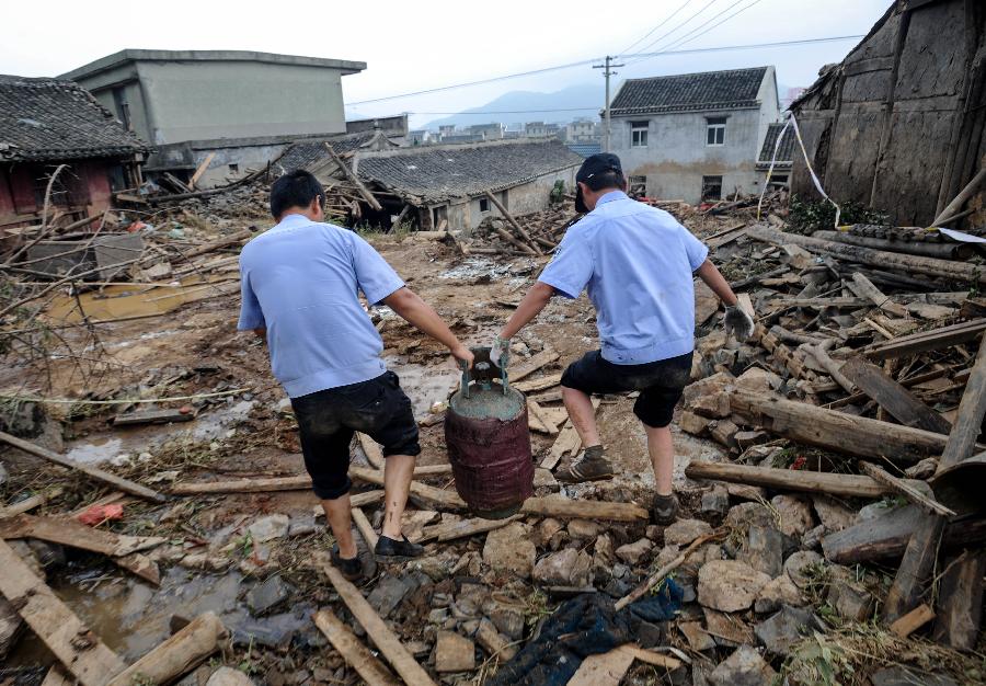 Rescuers work at the accident site after the dam of the Shenjiakeng Reservoir breached in Daishan County, east China's Zhejiang Province, Aug. 10, 2012. All-round rescue work was started after the collapse of the Shenjiakeng Reservoir on Friday, which claimed 11 lives and injured 27 people.