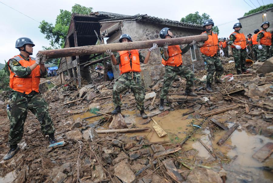 Rescuers work at the accident site after the dam of the Shenjiakeng Reservoir breached in Daishan County, east China's Zhejiang Province, Aug. 10, 2012. All-round rescue work was started after the collapse of the Shenjiakeng Reservoir on Friday, which claimed 11 lives and injured 27 people. 