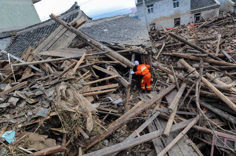 A rescuer works at the accident site after the dam of the Shenjiakeng Reservoir breached in Daishan County, east China's Zhejiang Province, Aug. 10, 2012. All-round rescue work was started after the collapse of the Shenjiakeng Reservoir on Friday, which claimed 11 lives and injured 27 people.