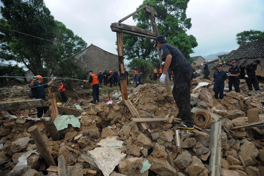 Rescuers work at the accident site after the dam of the Shenjiakeng Reservoir breached in Daishan County, east China's Zhejiang Province, Aug. 10, 2012. All-round rescue work was started after the collapse of the Shenjiakeng Reservoir on Friday, which claimed 11 lives and injured 27 people.