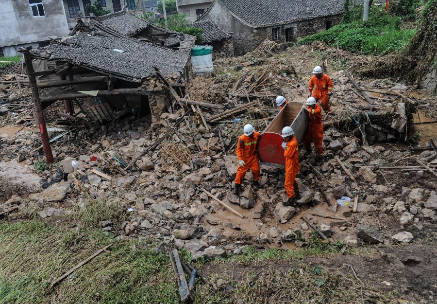 Rescuers work at the accident site after the dam of the Shenjiakeng Reservoir breached in Daishan County, east China's Zhejiang Province, Aug. 10, 2012. All-round rescue work was started after the collapse of the Shenjiakeng Reservoir on Friday, which claimed 11 lives and injured 27 people.