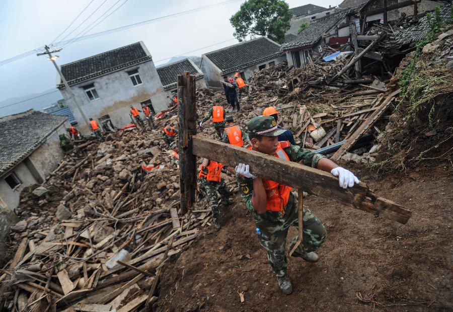 Rescuers work at the accident site after the dam of the Shenjiakeng Reservoir breached in Daishan County, east China's Zhejiang Province, Aug. 10, 2012. All-round rescue work was started after the collapse of the Shenjiakeng Reservoir on Friday, which claimed 11 lives and injured 27 people. 