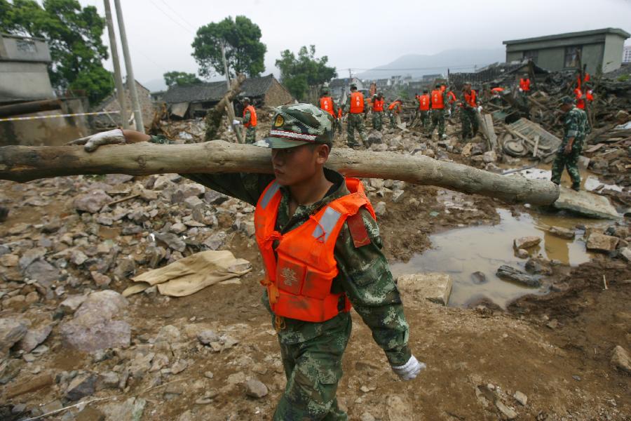 Rescuers work at the accident site after the dam of the Shenjiakeng Reservoir breached in Daishan County, east China's Zhejiang Province, Aug. 10, 2012. All-round rescue work was started after the collapse of the Shenjiakeng Reservoir on Friday, which claimed 11 lives and injured 27 people.