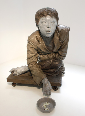 The art exhibition, held in Beijing's 798 art zone, interprets hunger, poverty, and food in a visually impressive way. The sculpture is named Beggar. [Zhang Fang/China.org.cn]