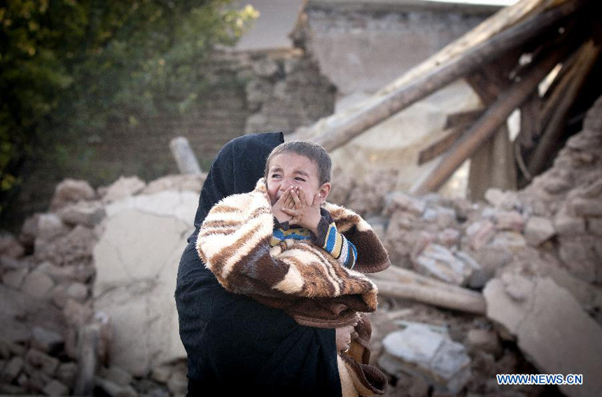 An Iranian child cries after an earthquake in Varzaqan in northwest Iran, on Aug. 12, 2012. The death toll of Saturday&apos;s strong twin quakes in northwest Iran has risen to some 300, the semi- official Fars news agency cited an official as saying on Sunday.