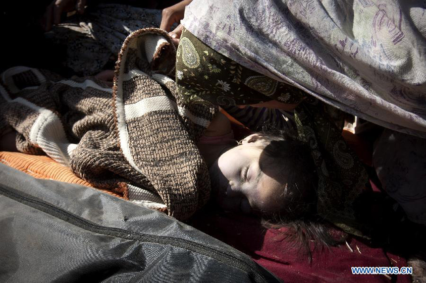 Photo taken on Aug. 12, 2012 shows the body of a girl who was killed in an earthquake in Varzaqan in northwest Iran. The death toll of Saturday&apos;s strong twin quakes in northwest Iran has risen to some 300, the semi- official Fars news agency cited an official as saying on Sunday. 