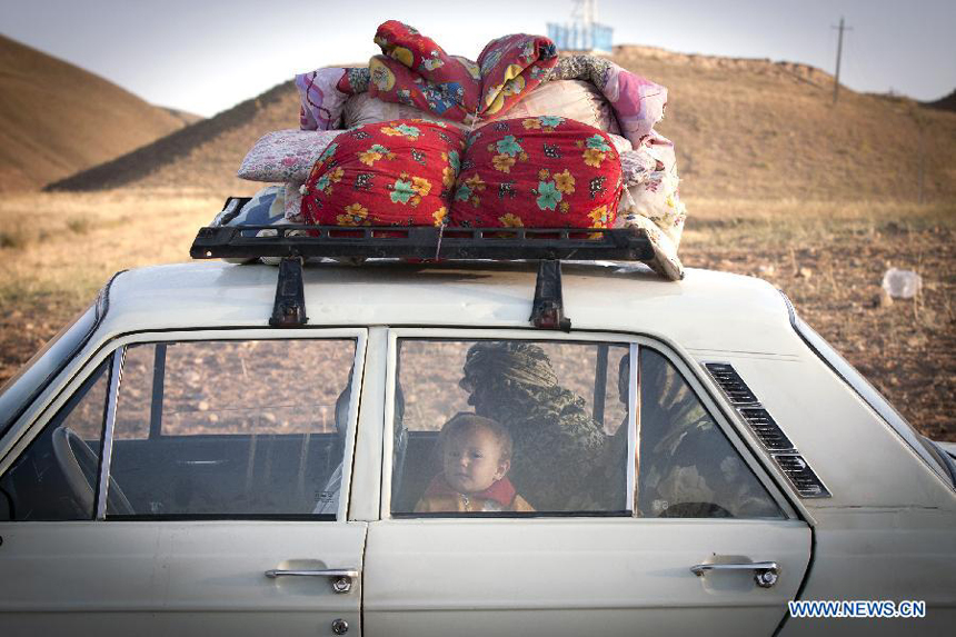 An Iranian child and two women are seen in a car after an earthquake in Varzaqan in northwest Iran, on Aug. 12, 2012. The death toll of Saturday&apos;s strong twin quakes in northwest Iran has risen to some 300, the semi- official Fars news agency cited an official as saying on Sunday.