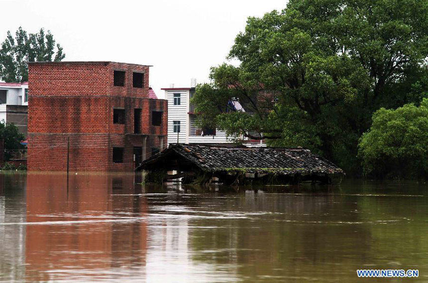 Photo taken on Aug. 11, 2012 shows inundated buildings after the wallop of Tyhpoon Haikui in Baiqiao Village of Lin&apos;gang Town in Leping City, east China&apos;s Jiangxi Province. The typhoon have had an impact on 1.13 million people in the province and China&apos;s central authorities initiated a level-four emergency plan on Saturday in response to torrential rains and flooding caused by typhoon Haikui in Jiangxi province.