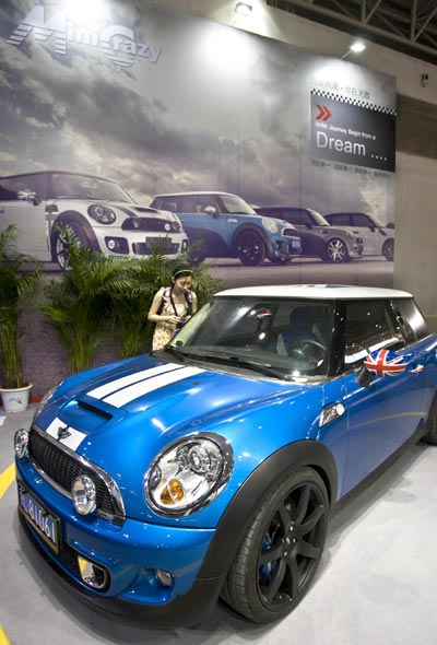 A visitor views a customized Mini Cooper on Aug 10, 2012, at the All in Tuning All in Caravaning Show China 2012, the National Agriculture Exhibition Center, Beijing. [Photo/Xinhua] 
