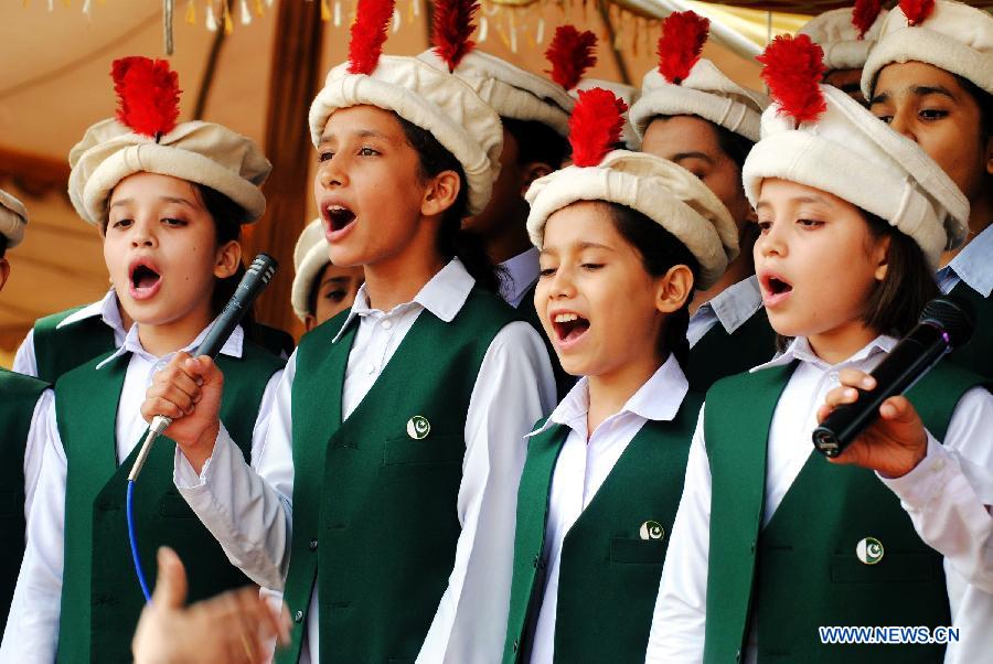 Pakistani students sing national anthem during a ceremony to celebrate 65th Pakistan's Independence Day in northwest Pakistan's Peshawar on Aug. 14, 2012. 