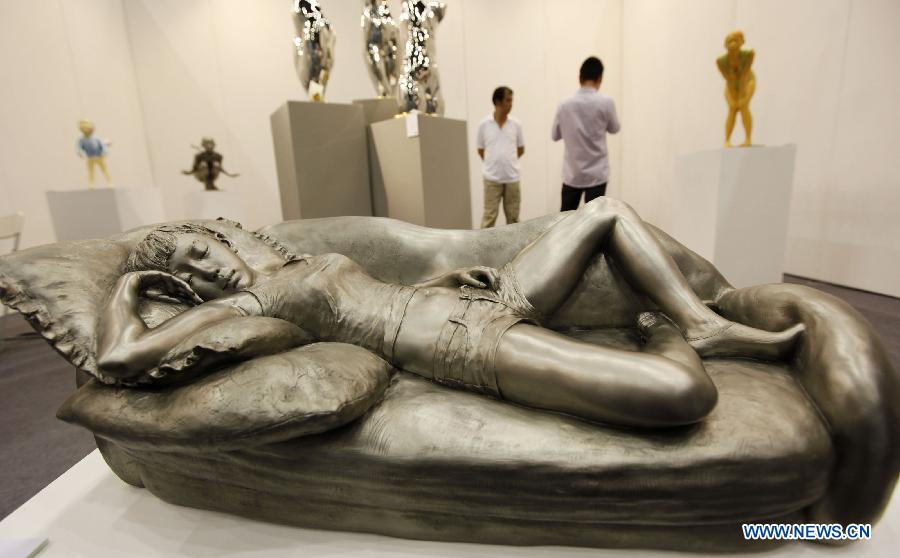 Photo taken on Aug. 15, 2012 shows a creative statue at a preview of Beijing Art Expo held in China World Trade Center in Beijing, capital of China. The five-day expo, which kicked off on Thursday, displays more than 5,000 art works provided by 90 arts institutions from 16 countries and regions.