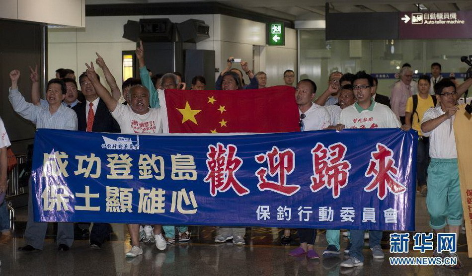 Seven of 14 Chinese nationals who were illegally detained by Japan after landing on the Diaoyu Islands arrive at Hong Kong International Airport at around 7:50 p.m. local time, August 17, 2012. All the 14 activists have been released. The other group of seven have also boarded a plane of Japan Coast Guard to fly to Ishigaki Island where their vessel was detained and will return later by their boat.