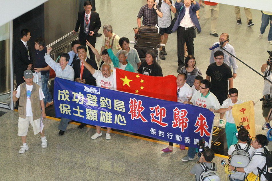 Seven of 14 Chinese nationals who were illegally detained by Japan after landing on the Diaoyu Islands arrive at Hong Kong International Airport at around 7:50 p.m. local time, August 17, 2012. All the 14 activists have been released. The other group of seven have also boarded a plane of Japan Coast Guard to fly to Ishigaki Island where their vessel was detained and will return later by their boat.