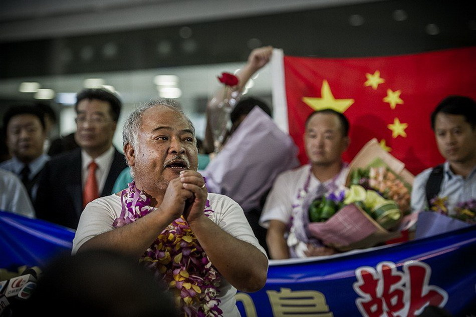 Seven of 14 Chinese nationals who were illegally detained by Japan after landing on the Diaoyu Islands arrive at Hong Kong International Airport at around 7:50 p.m. local time, August 17, 2012. All the 14 activists have been released. The other group of seven have also boarded a plane of Japan Coast Guard to fly to Ishigaki Island where their vessel was detained and will return later by their boat.