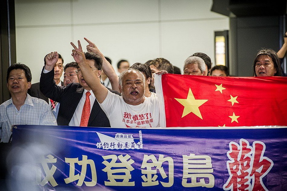 Seven of 14 Chinese nationals who were illegally detained by Japan after landing on the Diaoyu Islands arrive at Hong Kong International Airport at around 7:50 p.m. local time, August 17, 2012. All the 14 activists have been released. The other group of seven have also boarded a plane of Japan Coast Guard to fly to Ishigaki Island where their vessel was detained and will return later by their boat.