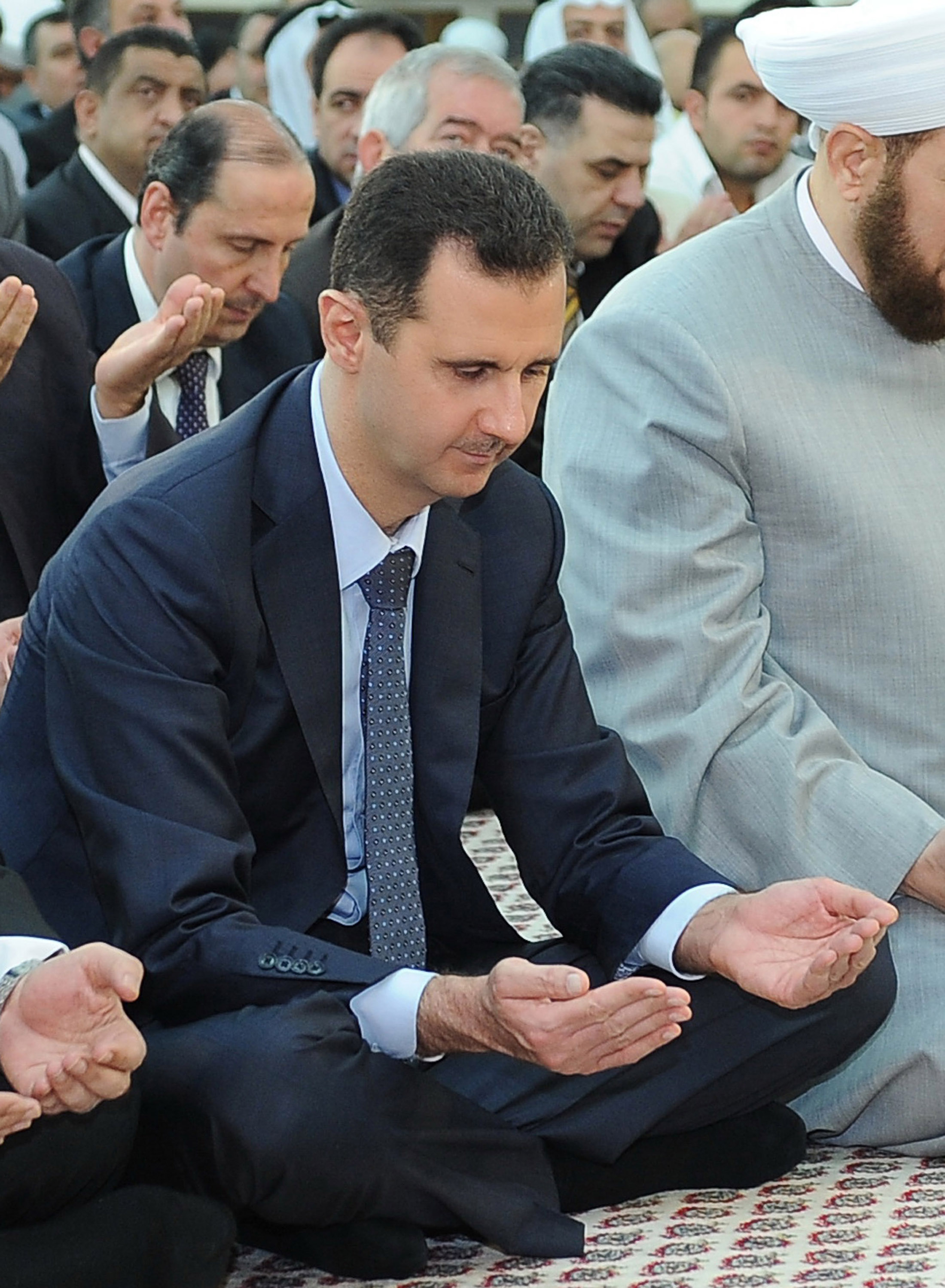 A handout picture released by the official Syrian Arab News Agency (SANA) on August 19, 2012 shows Syrian President Bashar al-Assad attending Eid al-Fitr payers in Damascus. [Xinhua]