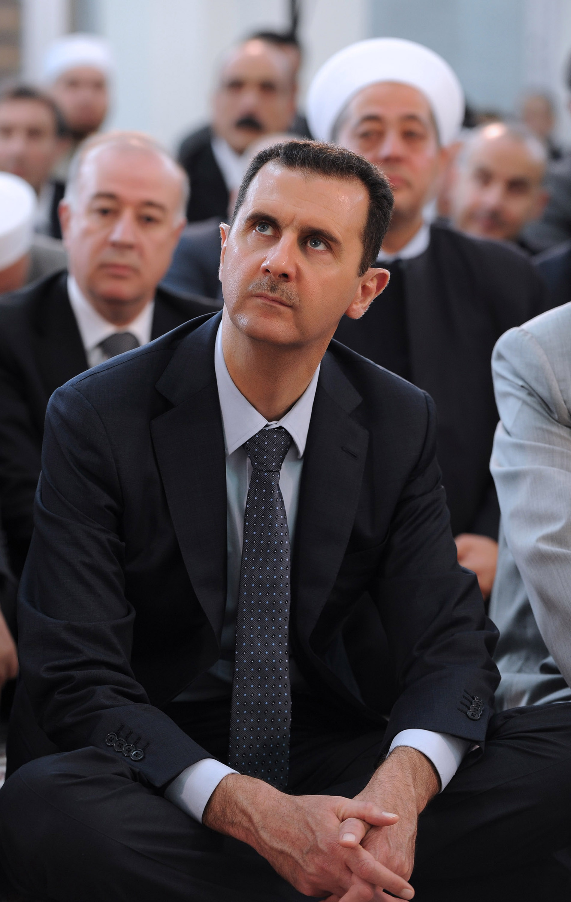 A handout picture released by the official Syrian Arab News Agency (SANA) on August 19, 2012 shows Syrian President Bashar al-Assad attending Eid al-Fitr payers in Damascus. [Xinhua] 