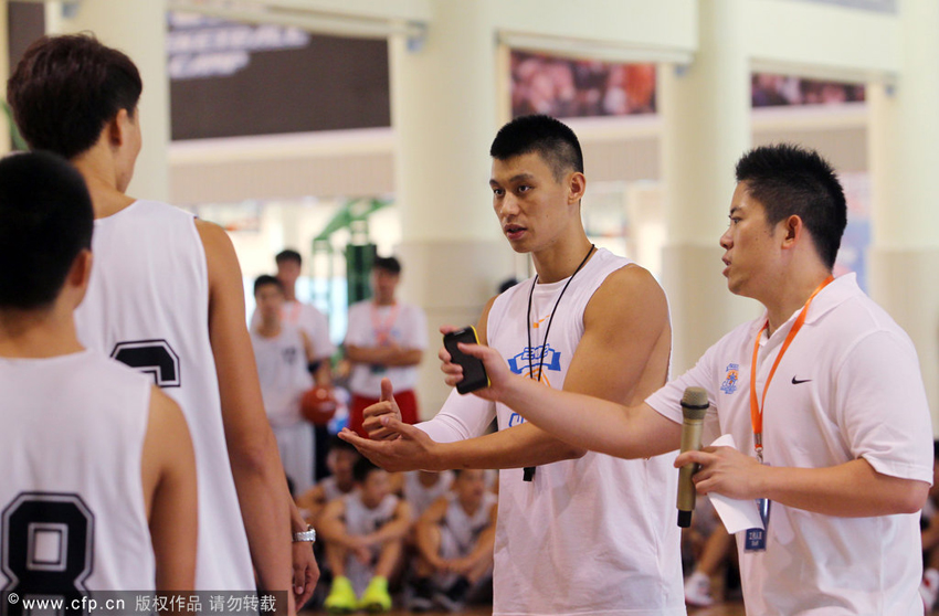 Jeremy Lin is giving instructions to kids at the opening day of J-Lin Basketball Camp 2012 in Dongguan, Guangdong Province on August 19, 2012.