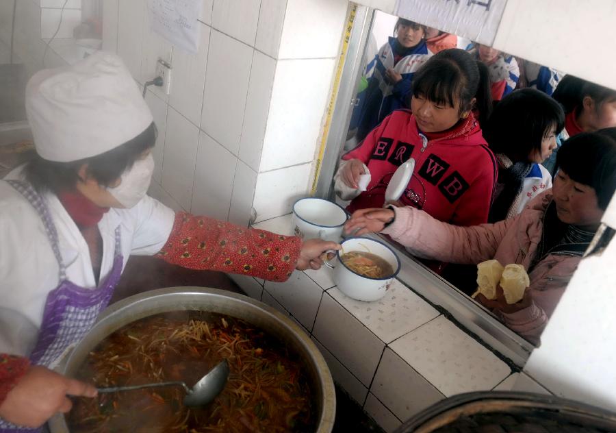 Students queue up to get lunch at the dining hall of the Chakouyi Middle School in Tianzhu Tibetan Autonomous Prefecture, northwest China's Gansu Province, March 12, 2012.