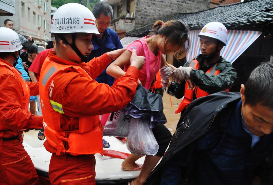 Public security and fire fighters help evacuate residents besieged by floods in Enyang Town, Bazhong City, Sichuan Province, on Sept. 1, 2012. The heavy rainfalls since Aug. 30 caused floods in part of Sichuan Province, forcing 62,600 people to evacuate and destroying 8,500 houses.