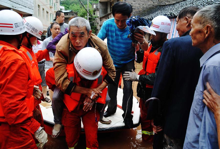 Public security and fire fighters help evacuate residents besieged by floods in Enyang Town, Bazhong City, Sichuan Province, on Sept. 1, 2012. The heavy rainfalls since Aug. 30 caused floods in part of Sichuan Province, forcing 62,600 people to evacuate and destroying 8,500 houses. 