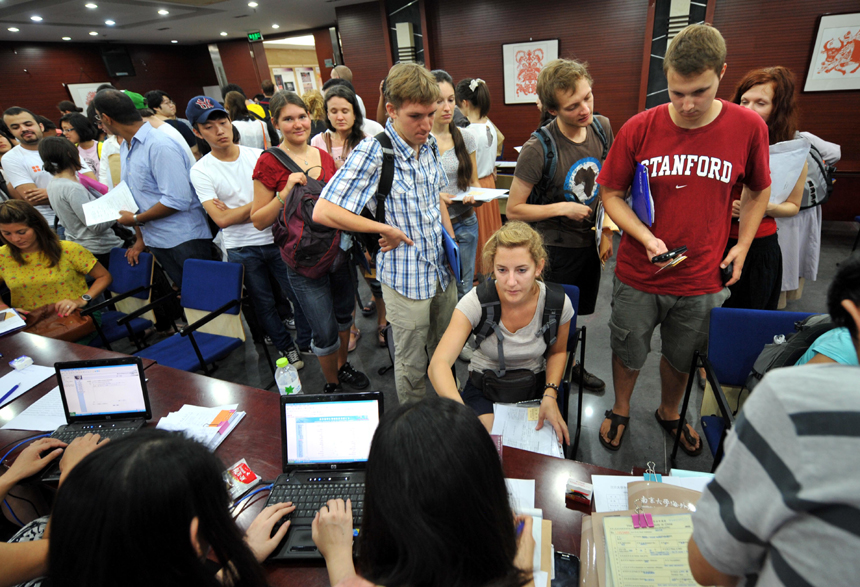 International students go through enrollment procedures at Nanjing University in Nanjing, Jiangsu Province, Sept. 3, 2012. Nearly 3,000 international students from more than 60 countries and regions were admitted to Nanjing University this year. [Xinhua photo]