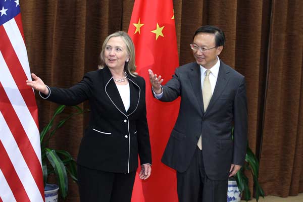 Foreign Minister Yang Jiechi shows the way forward with US Secretary of State Hillary Clinton in Beijing on Tuesday. [Feng Yongbin/China Daily]