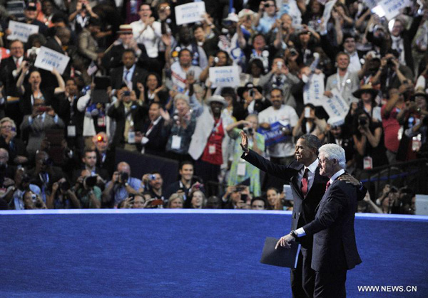 U.S. President Barack Obama (L) and former U.S. President Bill Clinton wave to the participants during the Democratic National Convention in Charlotte Sept. 5, 2012. U.S. Democrats nominated Obama to lead the party's presidential ticket during a roll call vote running through late Wednesday night to early Thursday. [Zhang Jun/Xinhua]