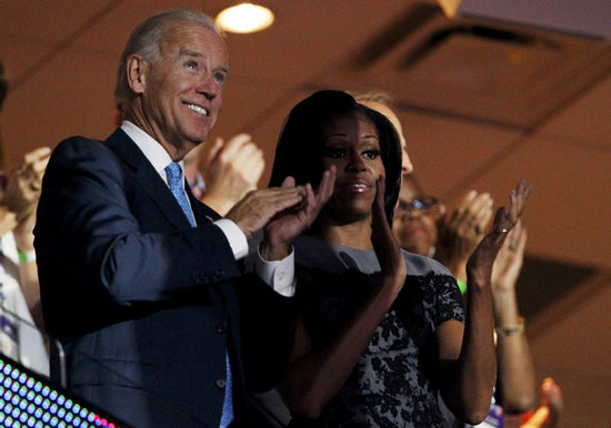 US Vice-President Joe Biden (L) and first lady Michelle Obama (R) applaud as they watch from the first lady's box during the second session of the Democratic National Convention in Charlotte, North Carolina, September 5, 2012. [Agencies] 