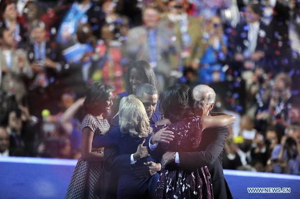 The family of U.S. President Barack Obama and the family of Vice President Joe Biden hug at the Democratic National Convention in Charlotte Sept. 6, 2012. U.S. President Barack Obama on Thursday night formally accepted the Democratic Party's presidential nomination, offering his own 'harder but better path' to rejuvenate support just two months ahead of the November election. [Zhang Jun/Xinhua]
