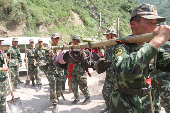 Rescuers help carry the injured people in earthquake zone on Sept. 8, 2012. Two earthquakes measuring over 5 struck Weining's neighboring Yiliang County in southwest China's Yunnan Province on Friday. 